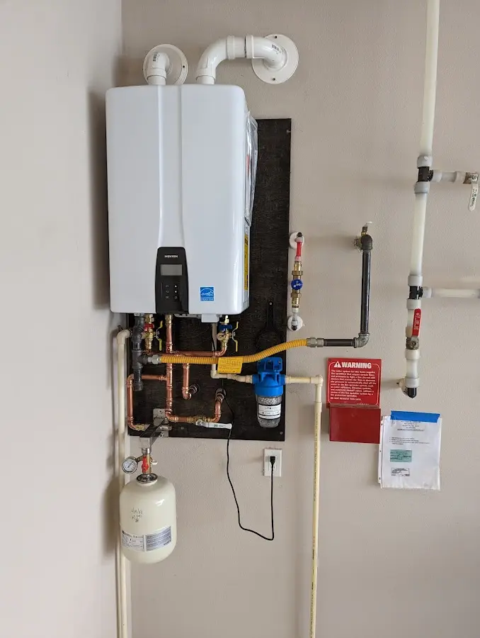 Professional plumber installing copper piping in a Commercial Point home